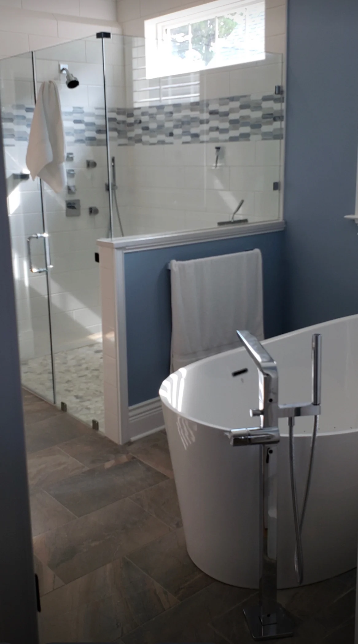 Spa-inspired shower with glass enclosure after renovation